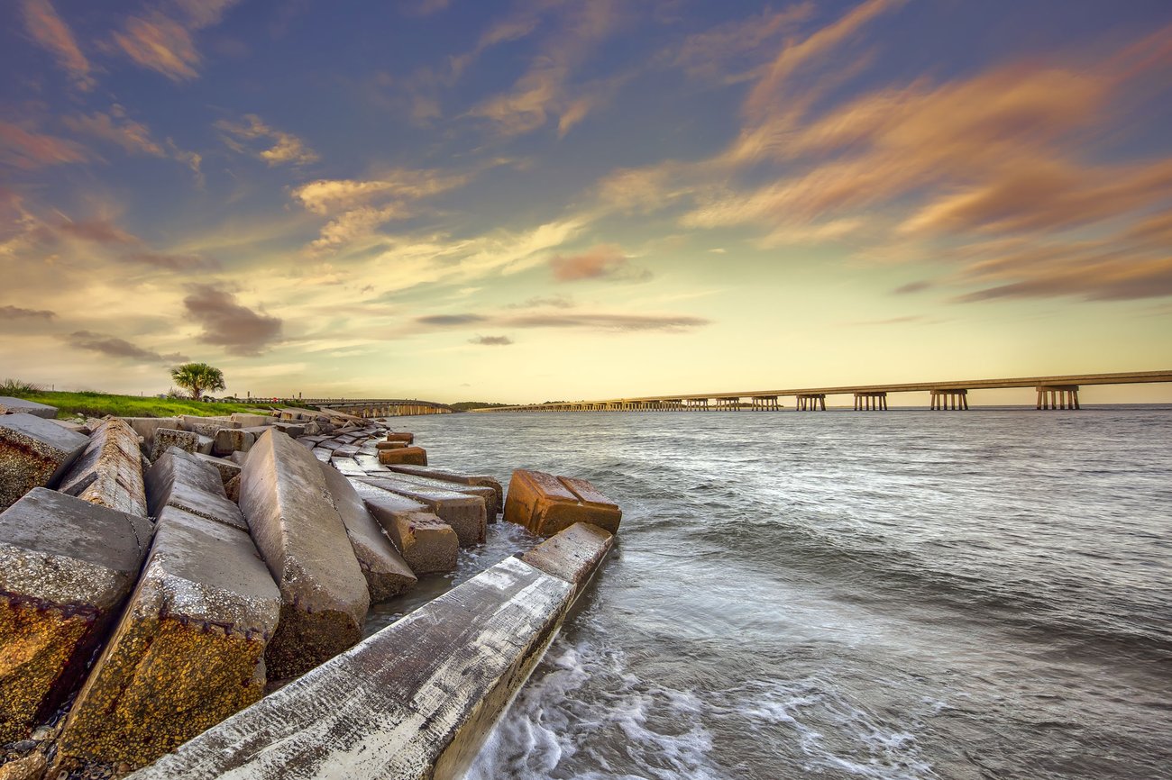 View of Jacksonville beach and pier at sunrise on a Florida Flight + Hotel JetBlue Vacations package