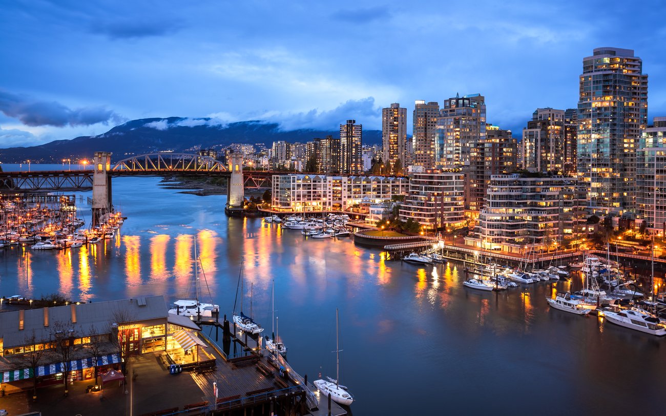Sunset view of Vancouver, Canada at sunset with mountains in background with JetBlue Flight + Hotel Vacation Package