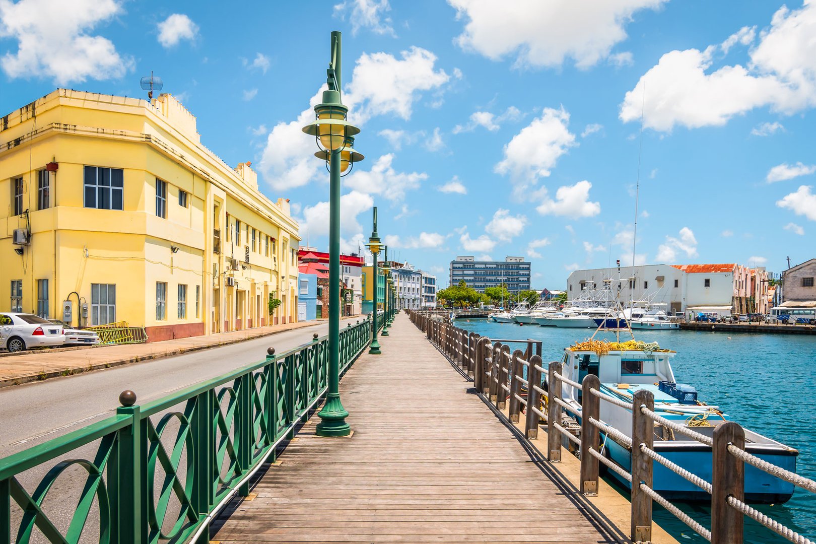 View of boardwalk, boat and architecture in Barbados on a JetBlue Vacations Flight + Cruise Package