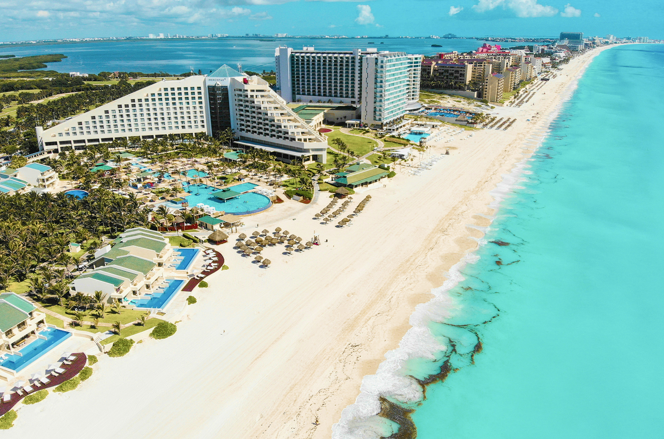 Aerial view of Cancún Hotel Zone beachfront resorts and white-sand shoreline along the turquoise sea