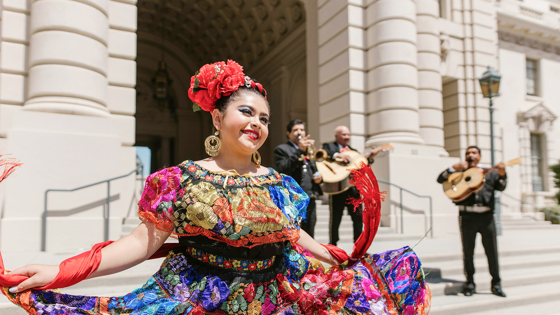 Mexican folkloric dancer in a colorful embroidered dress performing with a mariachi band in Cancún