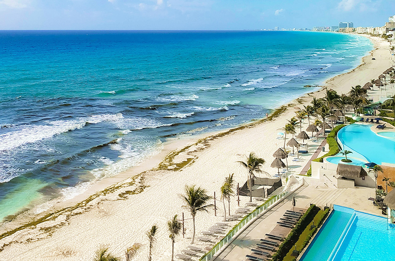 Aerial shot of Riviera Cancún resort coastline with white-sand beach, and clear blue ocean