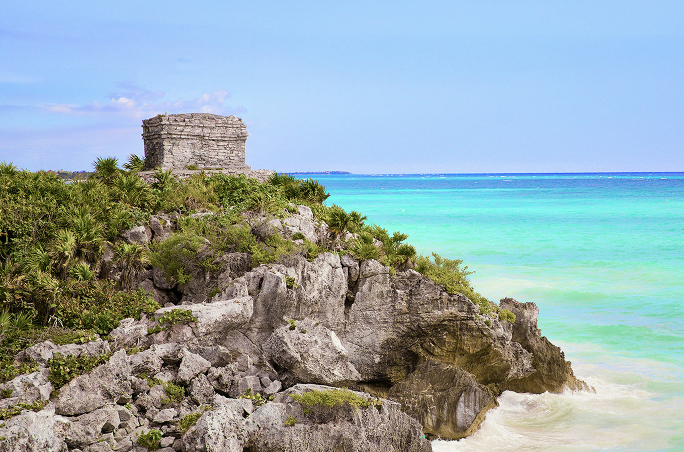 Mayan temple ruins perched on limestone cliffs overlooking the turquoise Caribbean Sea at Tulum near Cancún