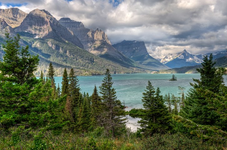 Aerial view of trees, water and mountains in Bozeman, Montana on a Flight + Hotel vacation package