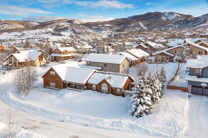 Aerial view of Steamboat Springs, Colorado with homes and mountains on Flight + Hotel all inclusive vacation package