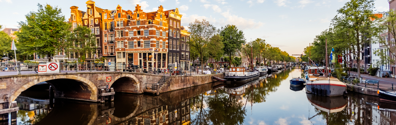 Canal, bridges and city view of Amsterdam on an all inclusive JetBlue Vacations package to Europe