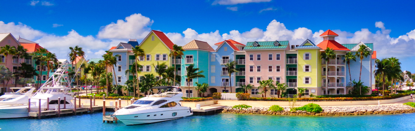 View of colorful architecture and beach in Nassau on a JetBlue Vacations all inclusive Bahamas package