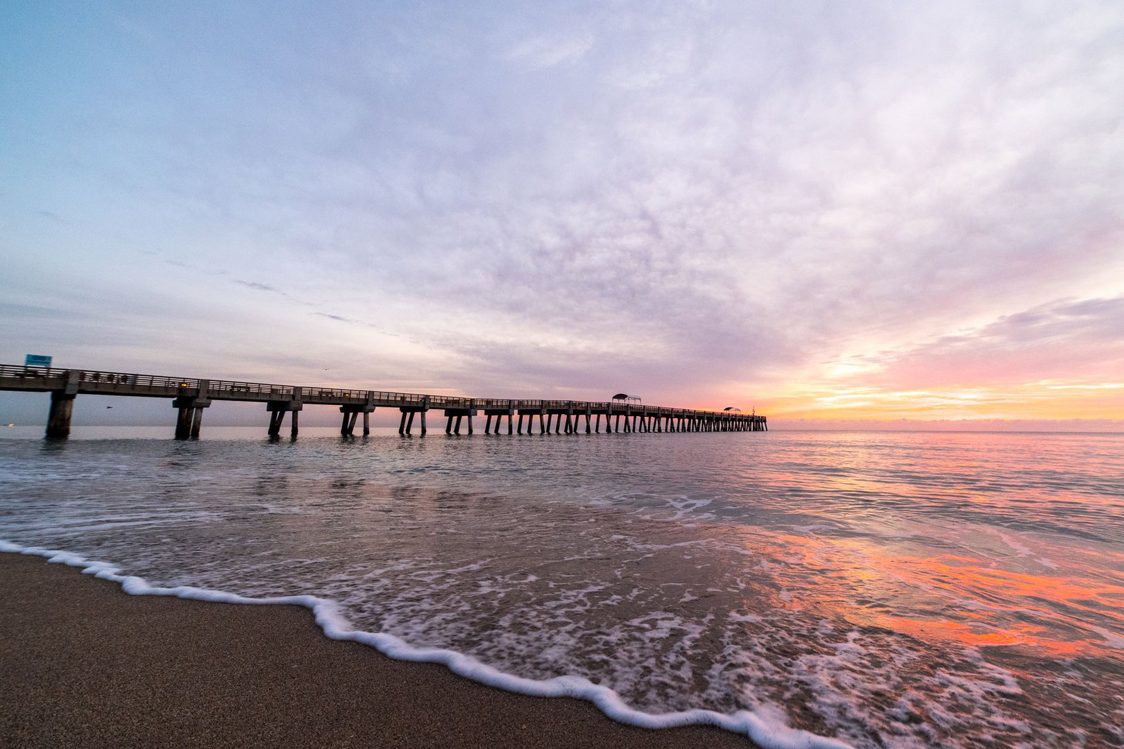 Aerial view of beach and pier on a West Palm Beach Flight + Hotel all inclusive JetBlue Vacations package