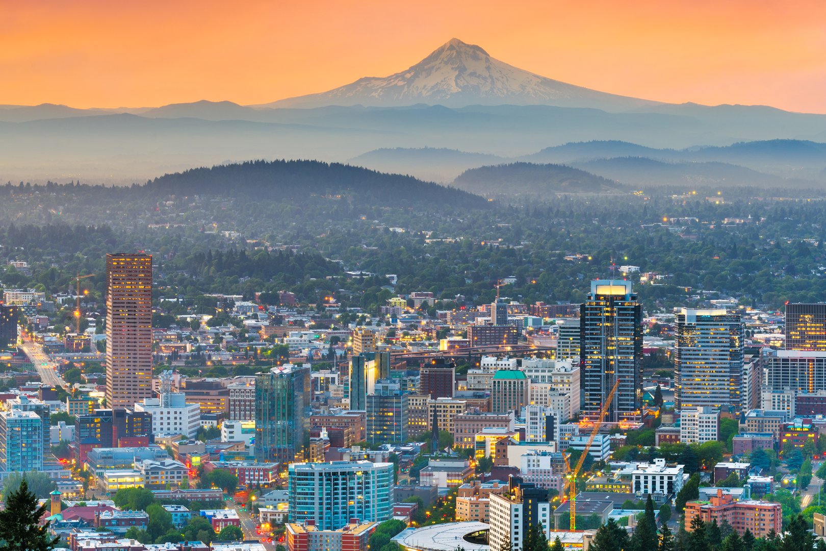 Panoramic view of Portland skyline and mountains at sunset during a Portland JetBlue Vacations Flight + Hotel package