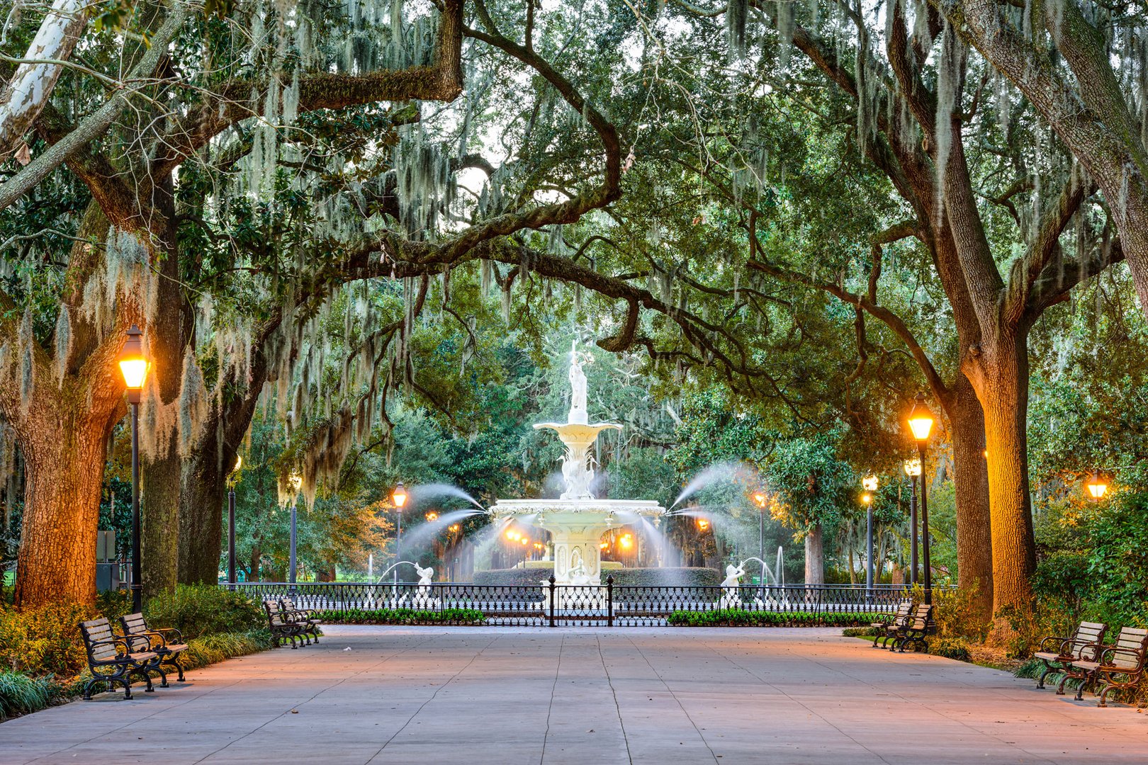 View of tree canopy over road with fountain in Savannah on a JetBlue Vacations all inclusive package to Georgia