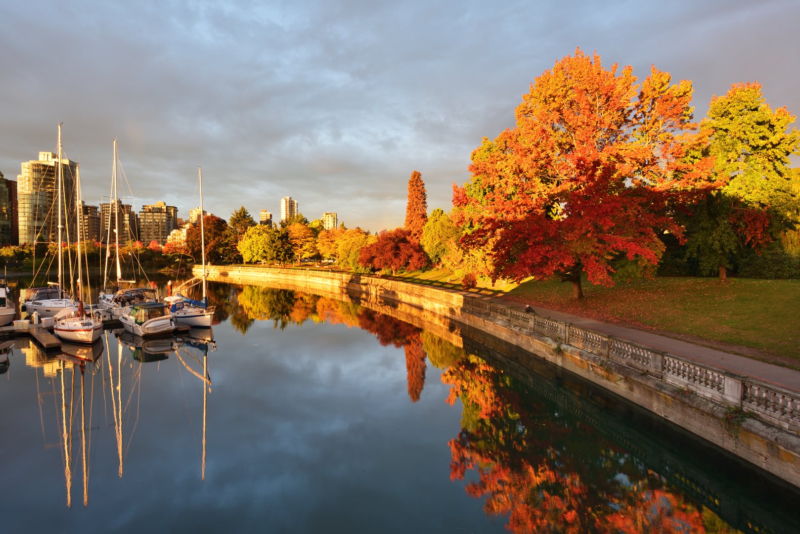 Sailboats in harbor, fall foliage at Stanley Park Vancouver, Canada on an All-Inclusive Flight + Hotel Vacation Package