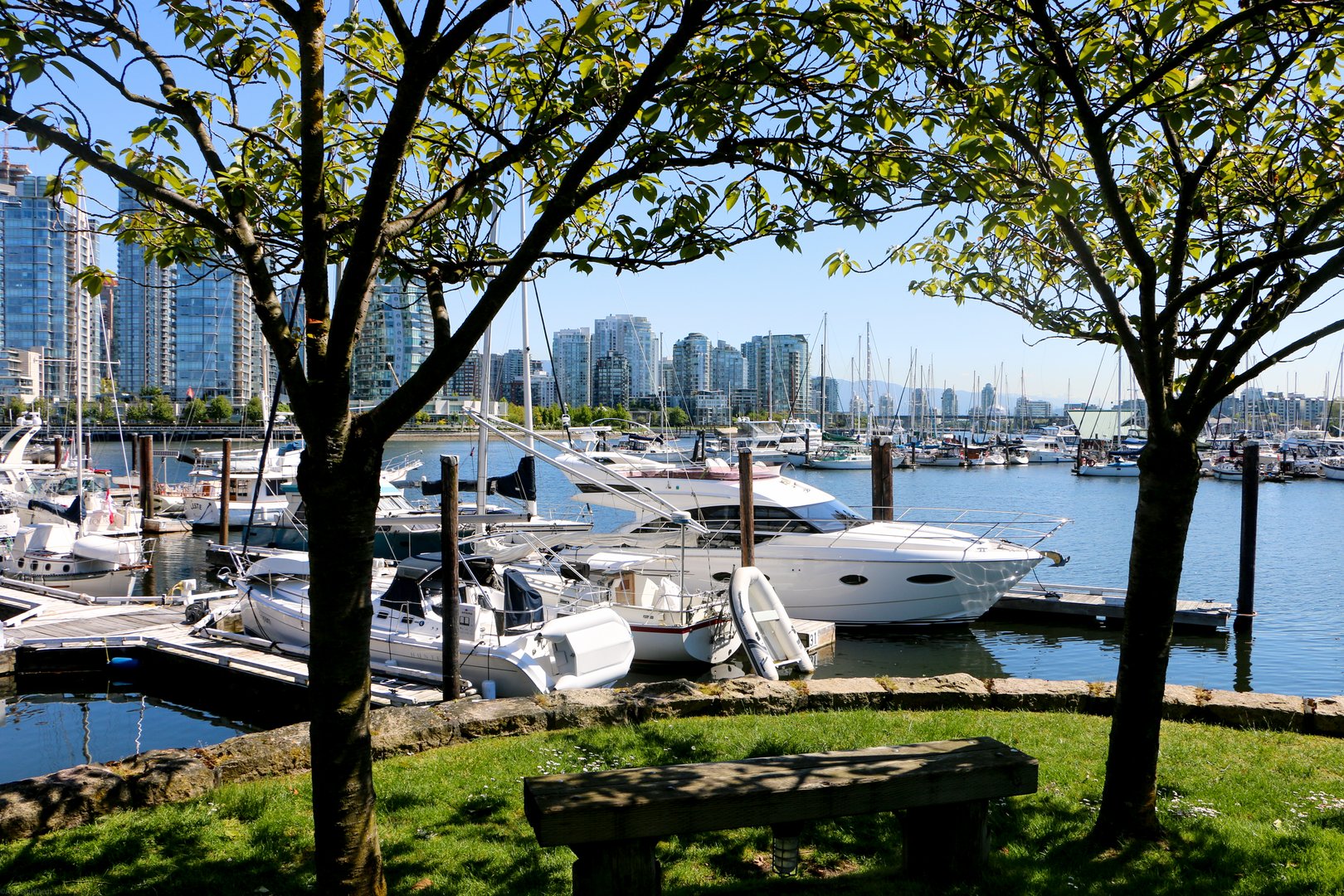 Boats in harbor with city in background in Granville Island Vancouver, Canada on a JetBlue Vacations Flight + Hotel Package
